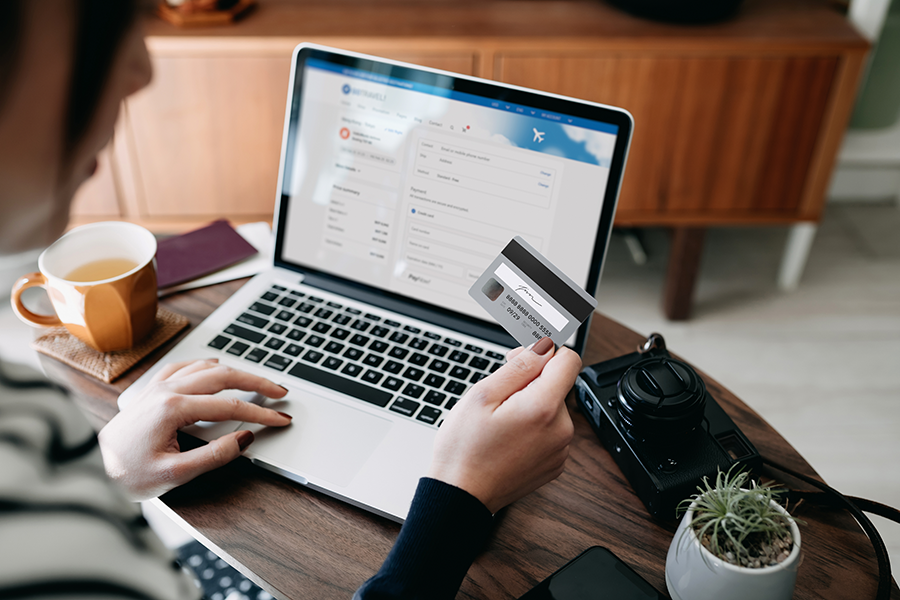 woman with a credit card and a laptop