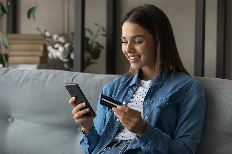 woman with phone and debit card